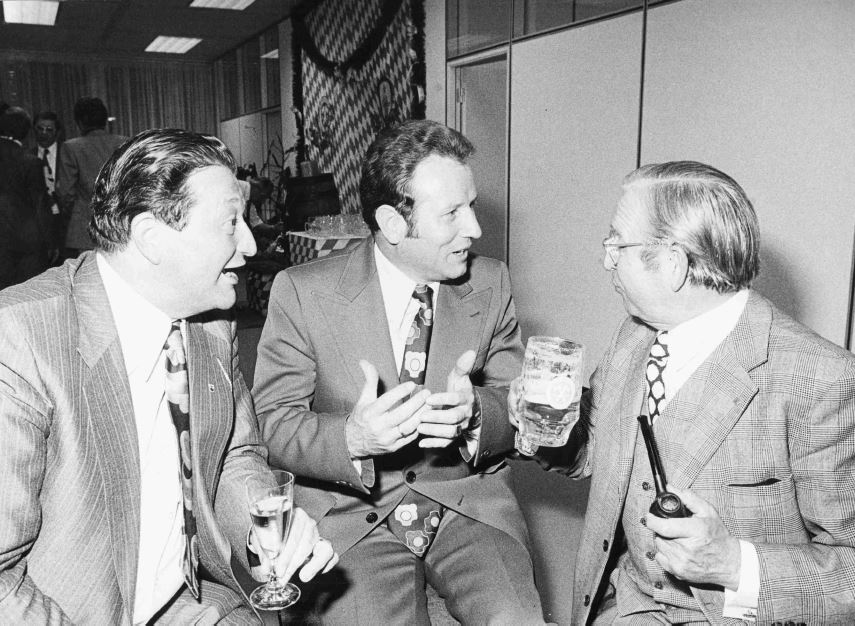 Der Abend: feucht-fröhlich! Die Krawatte: sitzt! 1975 feiert der damalige Geschäftsführer Hans Bens (links) die Eröffnung der Geschäftsstelle München.